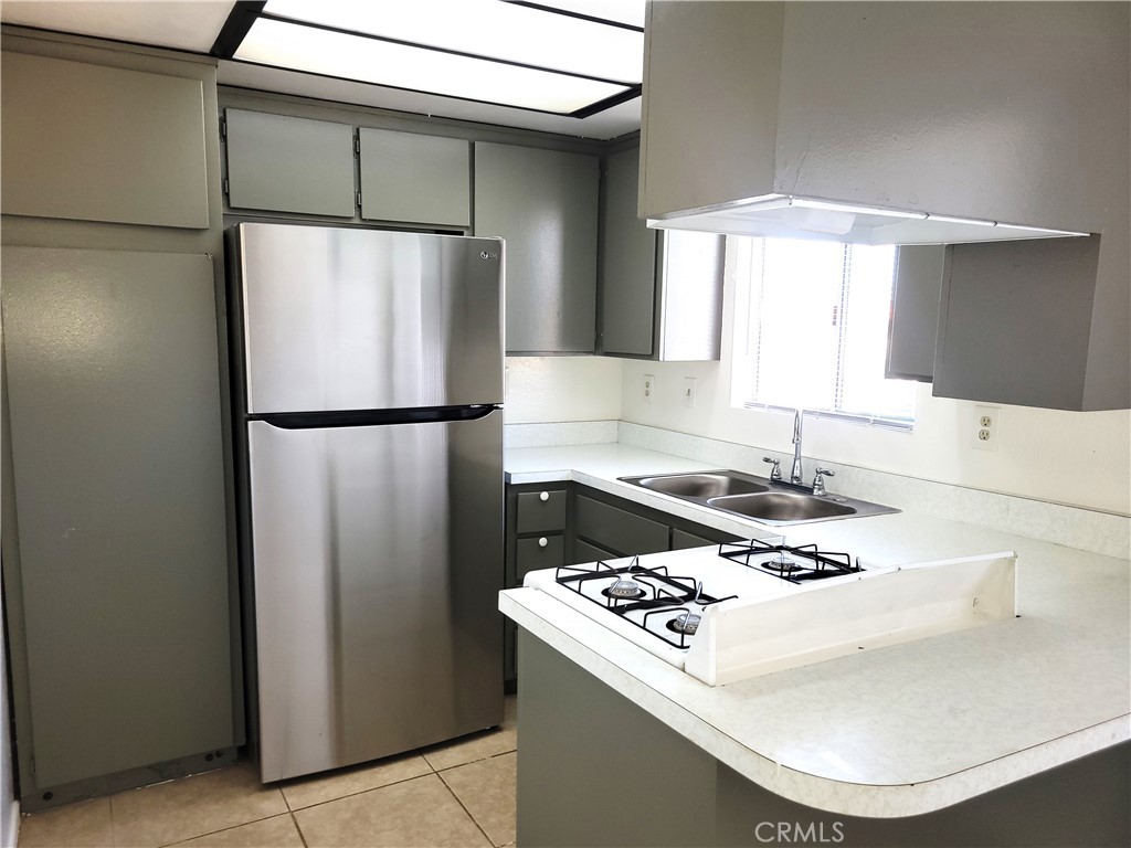 a kitchen with a white stove top oven and refrigerator