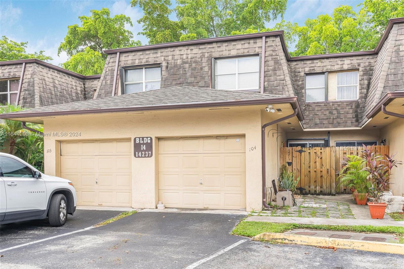 a view of a car parked front of a house