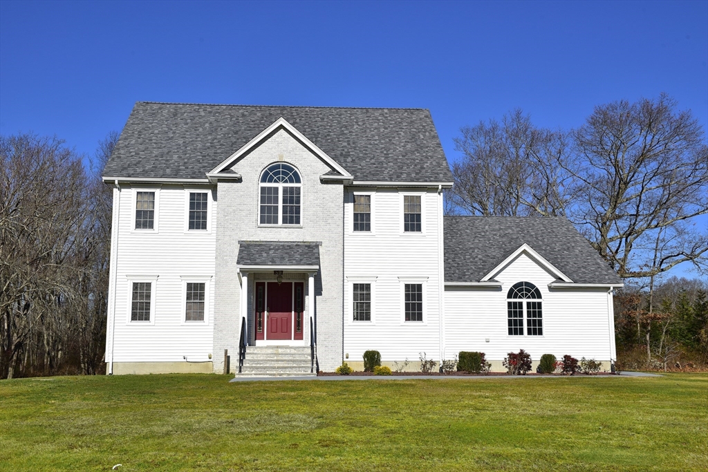 a front view of a house with a yard