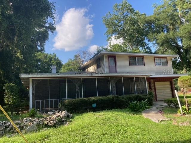 a view of house with a yard