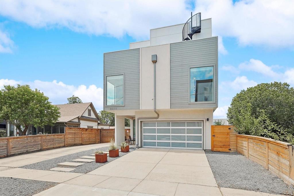 a backyard of a house with barbeque oven and outdoor seating