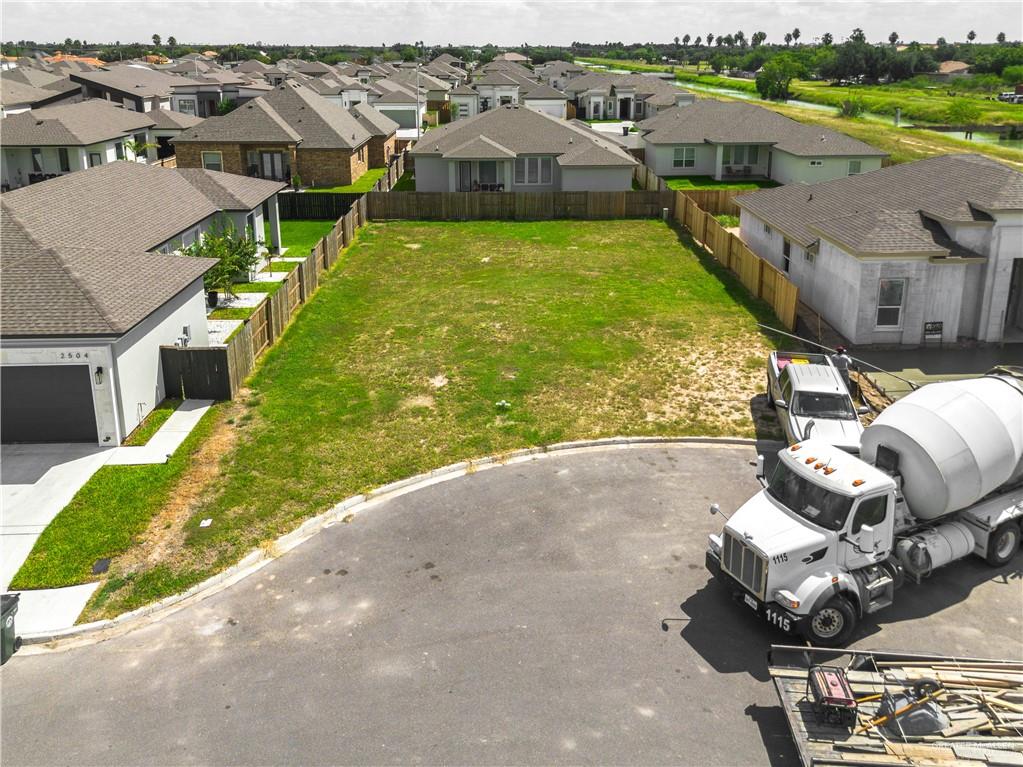 an aerial view of a house with garden space and street view