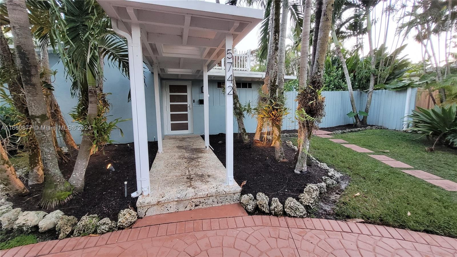 a front view of a house with garden