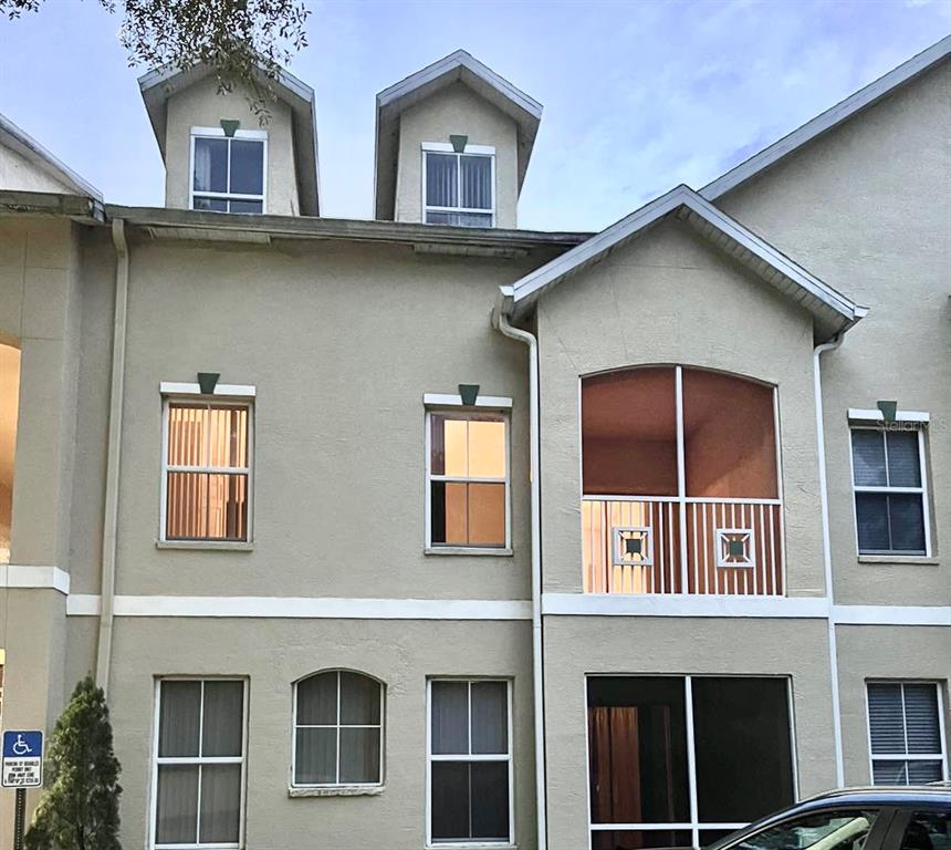 a front view of residential houses with parking