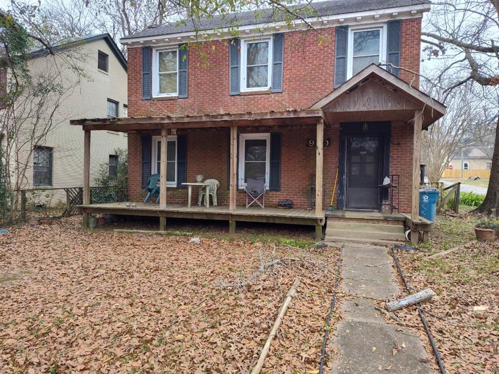 a view of a house with large windows and a yard