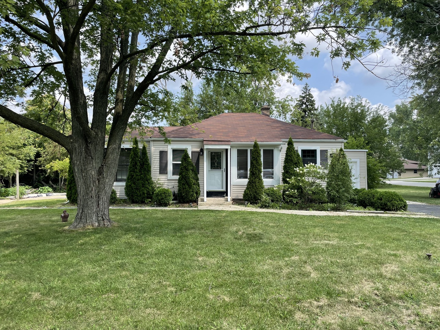 a front view of a house with a garden