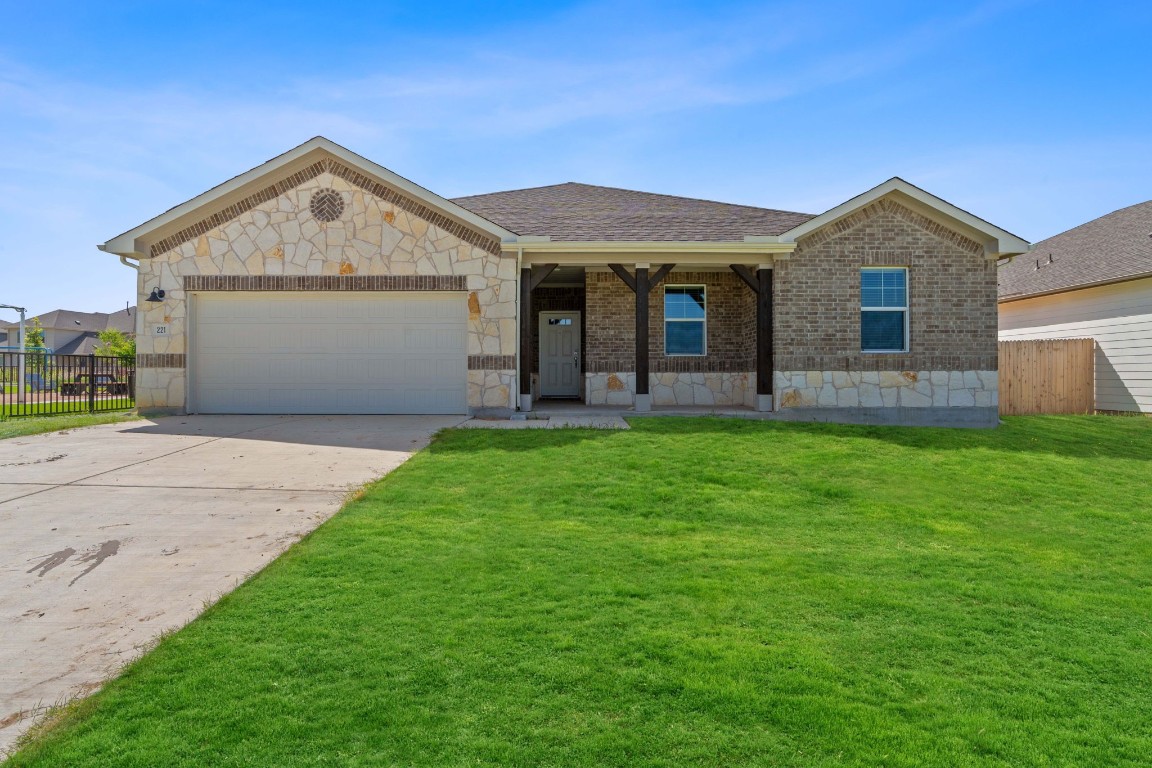 a front view of house with yard and green space