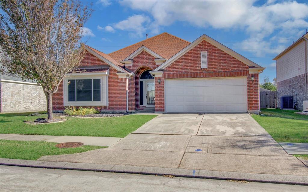 Front elevation of a very nice spacious single story home with many upgrades and an extended driveway, great for family and guests.