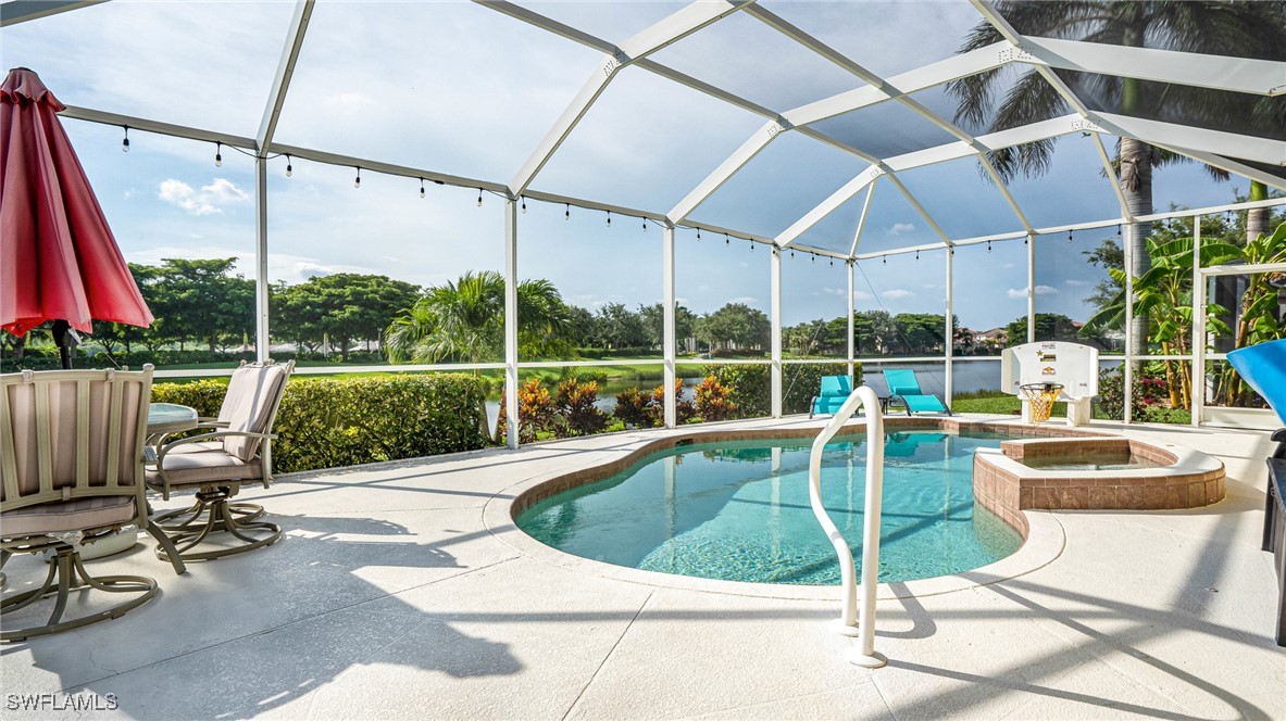 a view of a swimming pool with a patio and a yard