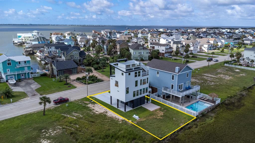 an aerial view of multiple houses with a yard