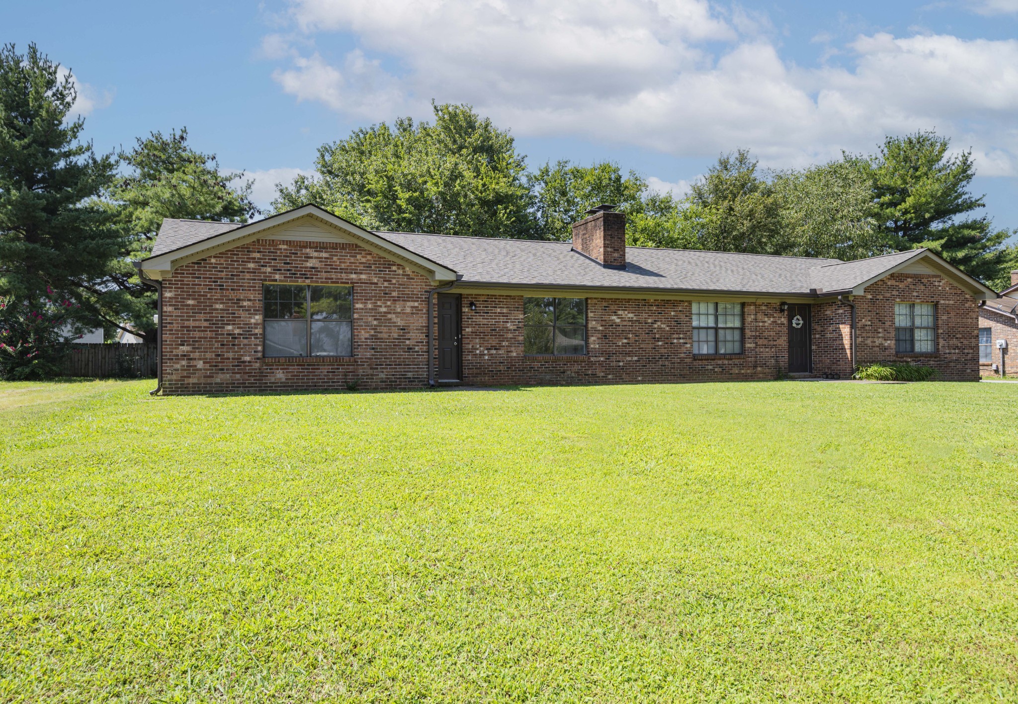 a front view of house with yard and swimming pool