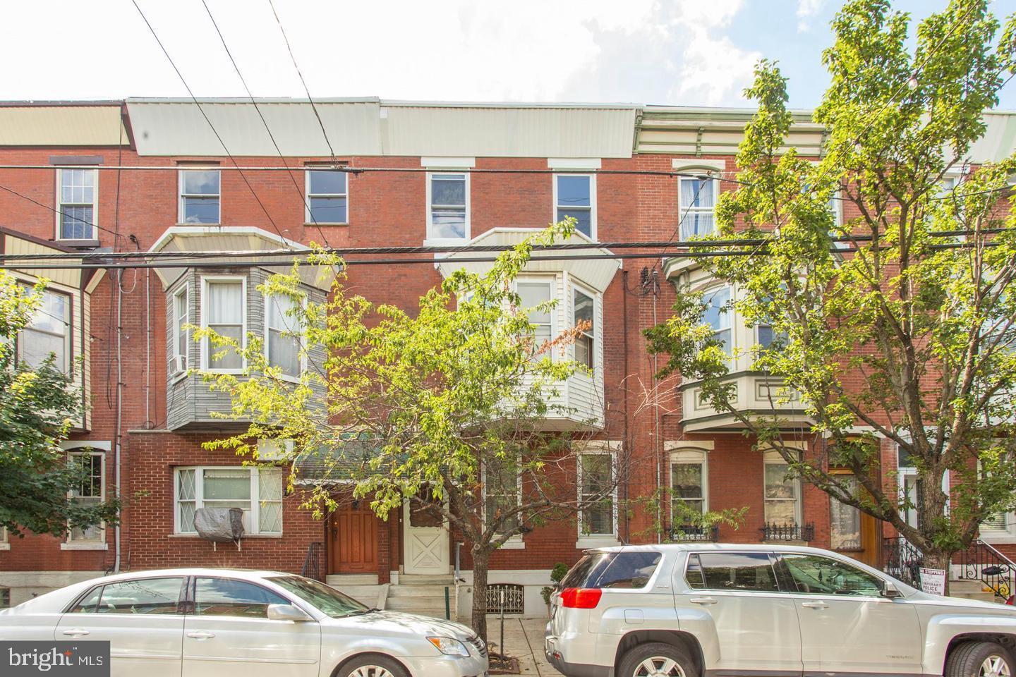 a front view of a residential apartment building with a yard