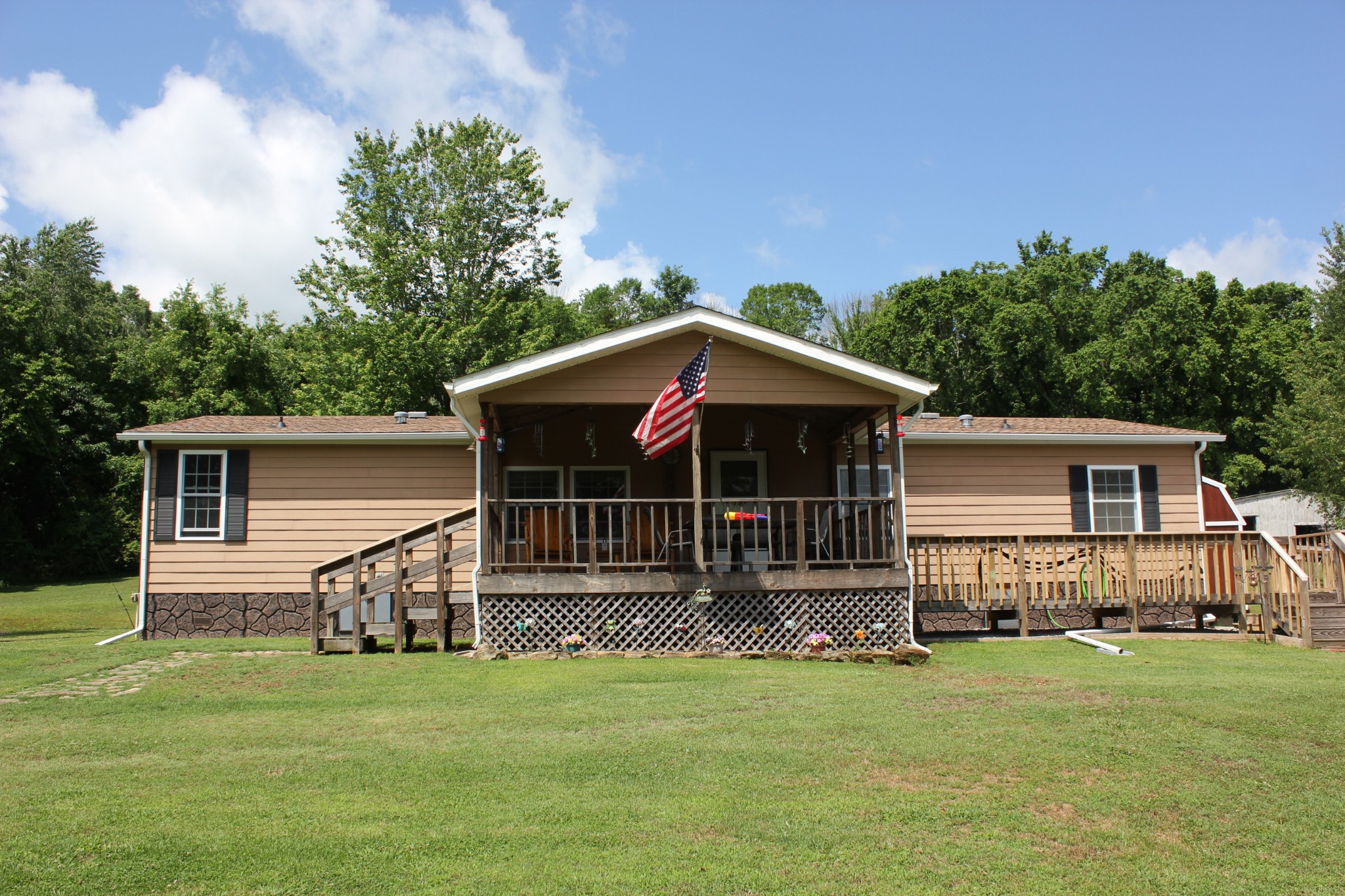 a front view of a house with a garden