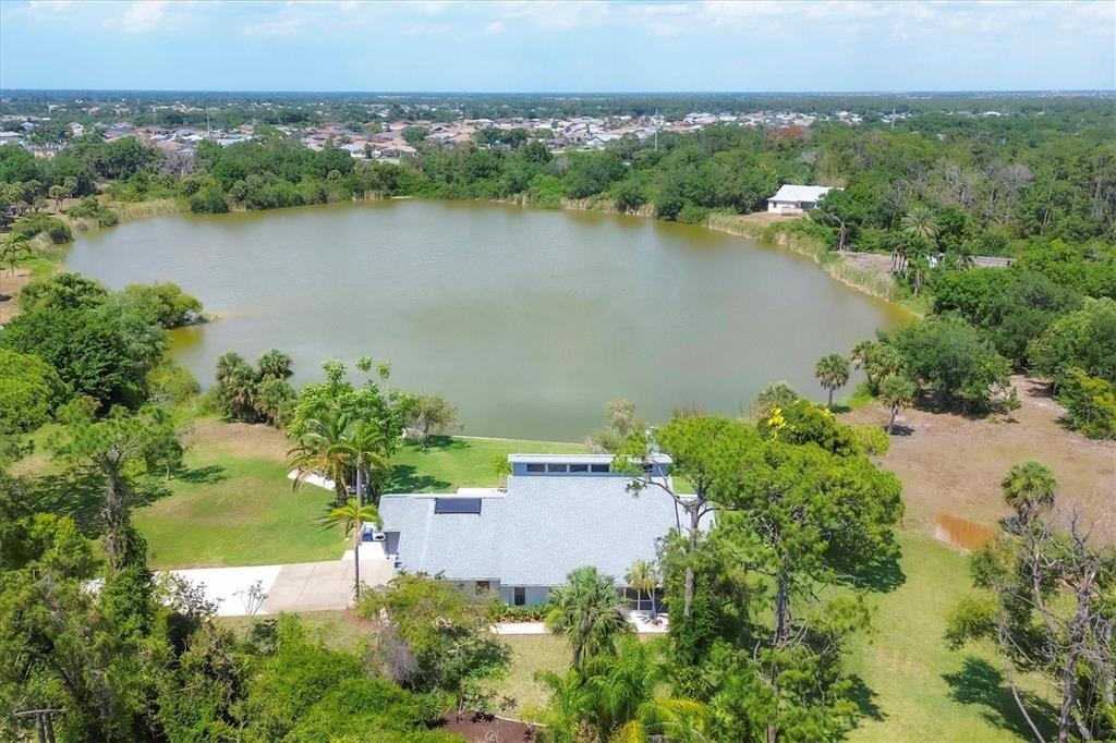 an aerial view of a houses with a lake view