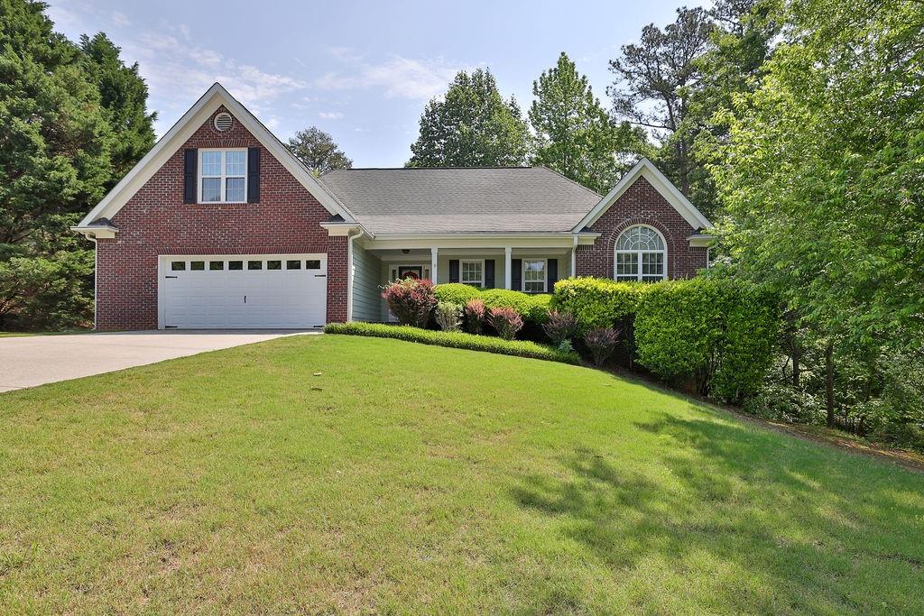 a front view of a house with garden