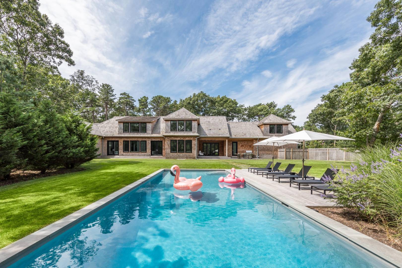 a view of a house with swimming pool and yard