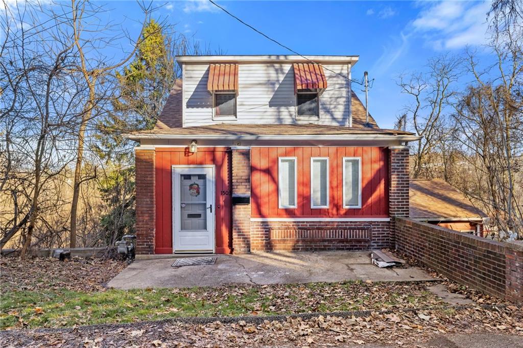 a view of small house with a yard