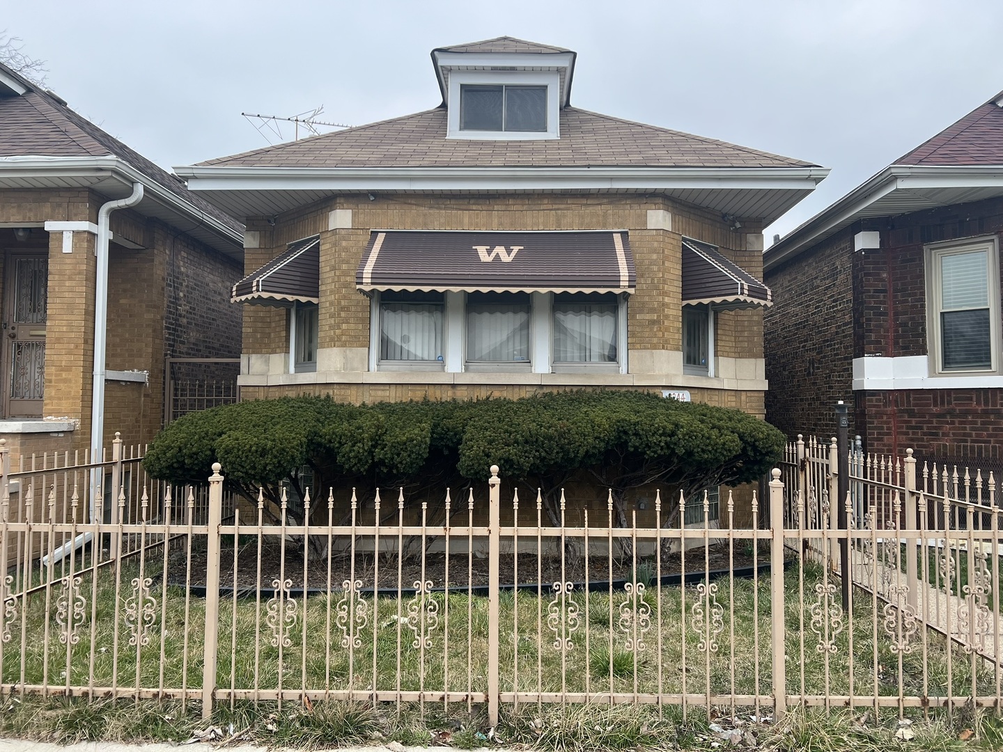 a front view of a house with a garden