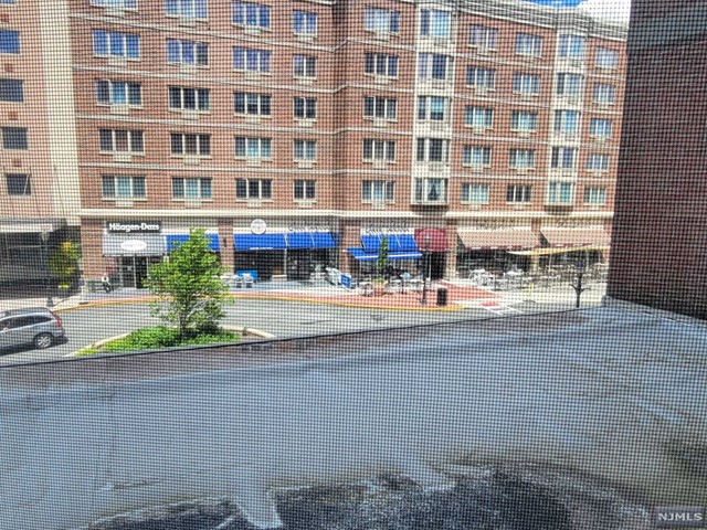 a picture of street with building and bench