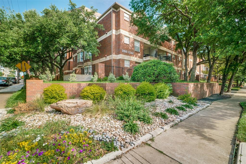 a front view of a house with a yard and fountain in middle