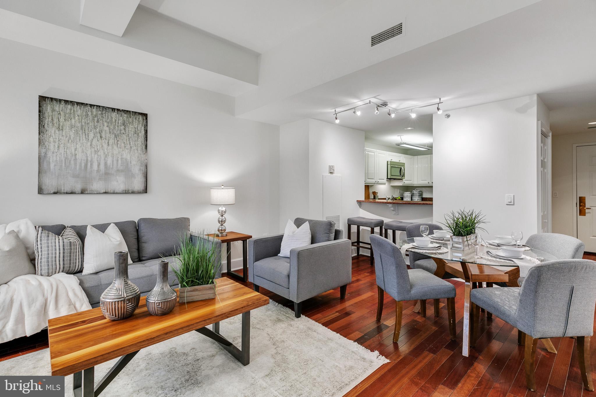 a living room with furniture and wooden floor