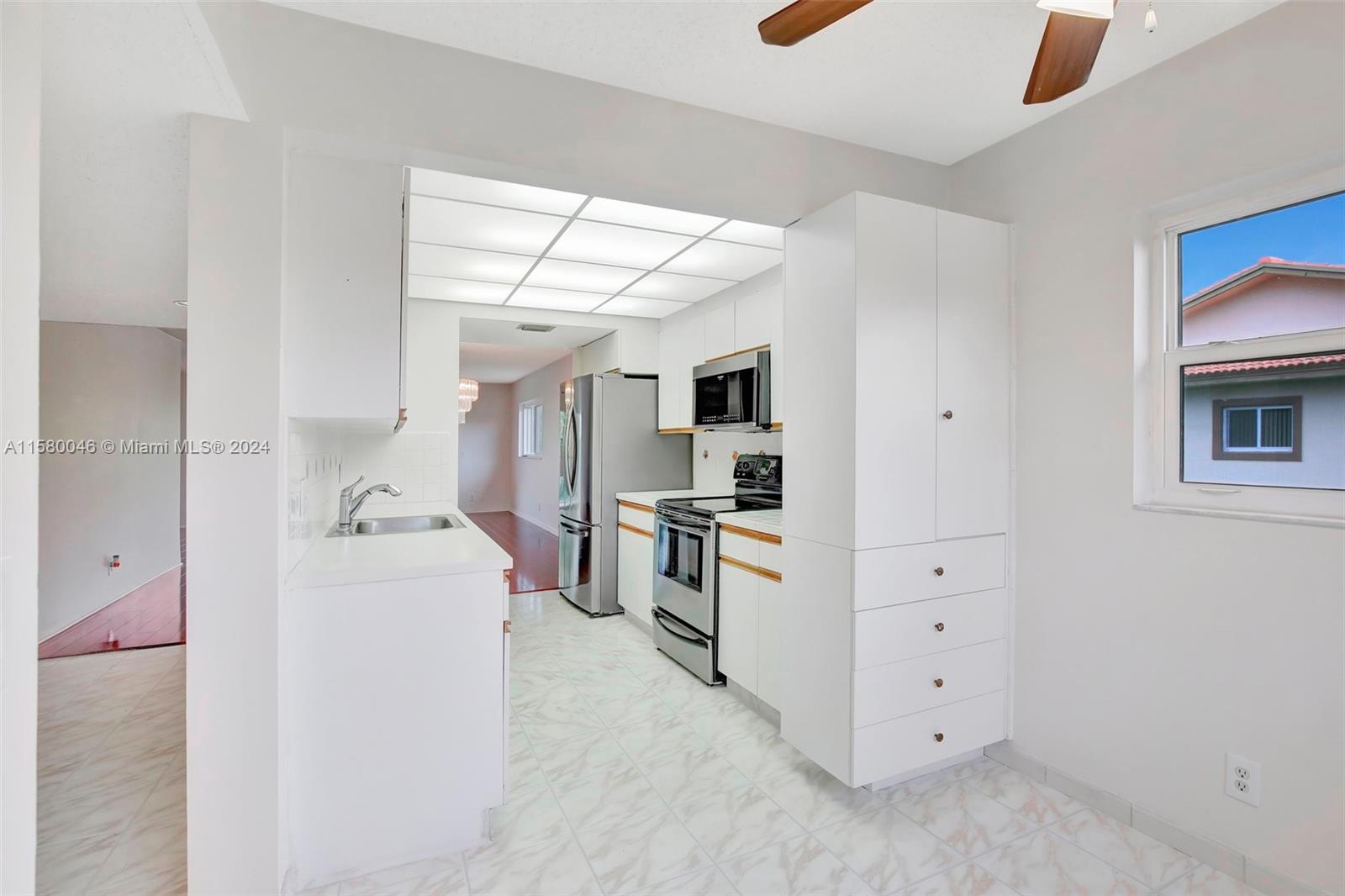 a kitchen with cabinets and window