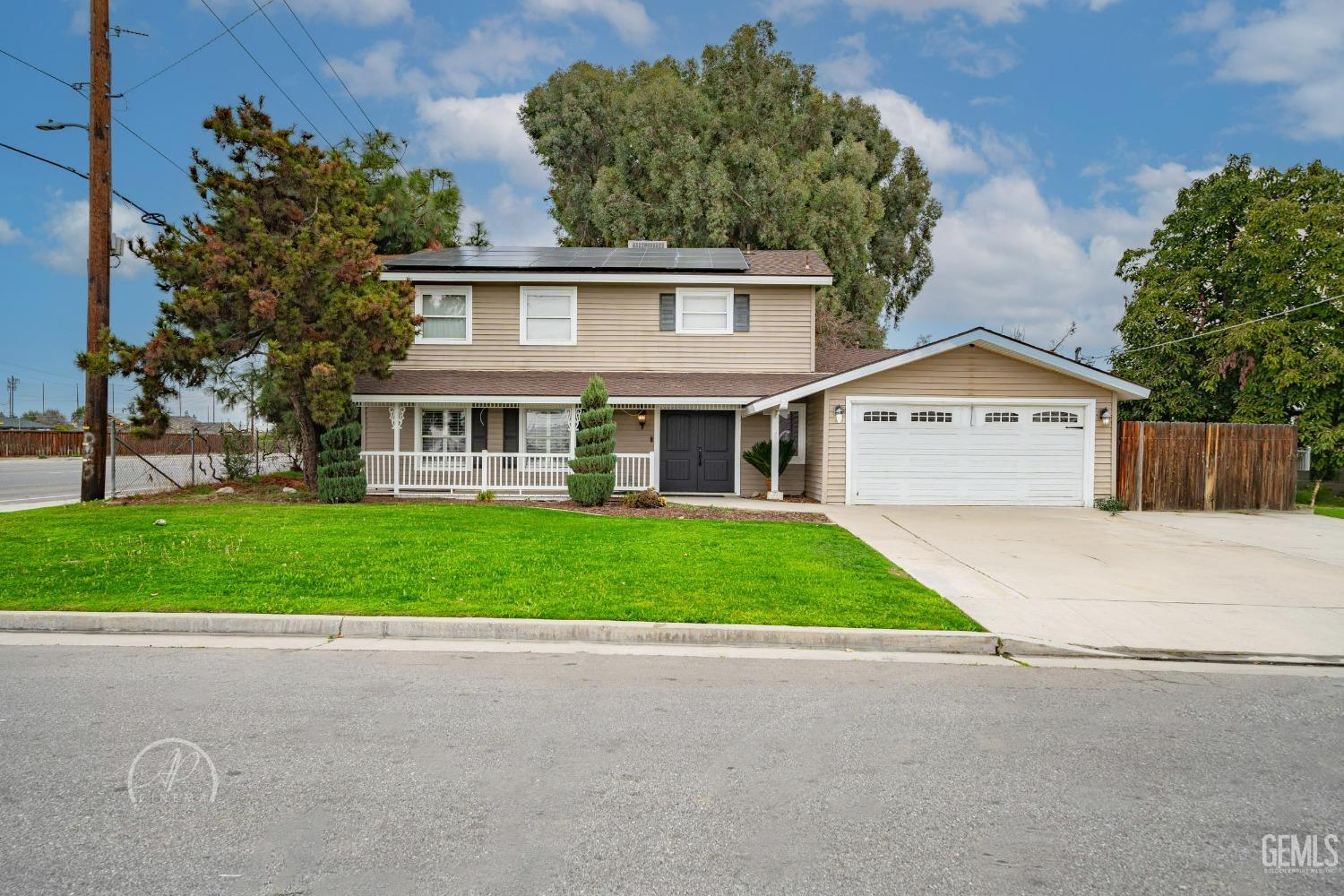 a front view of a house with garage and yard