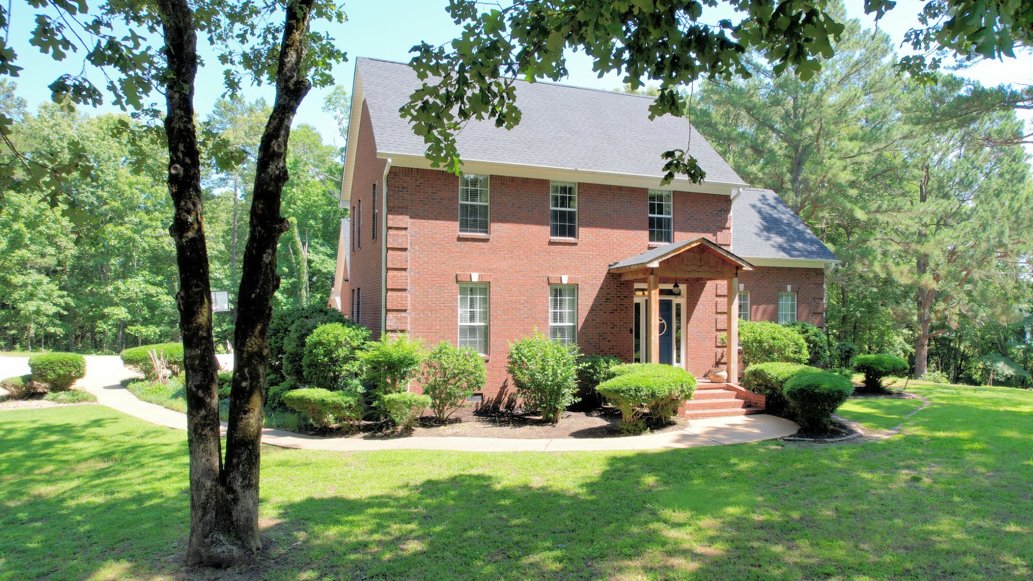 a front view of a house with a yard and a porch