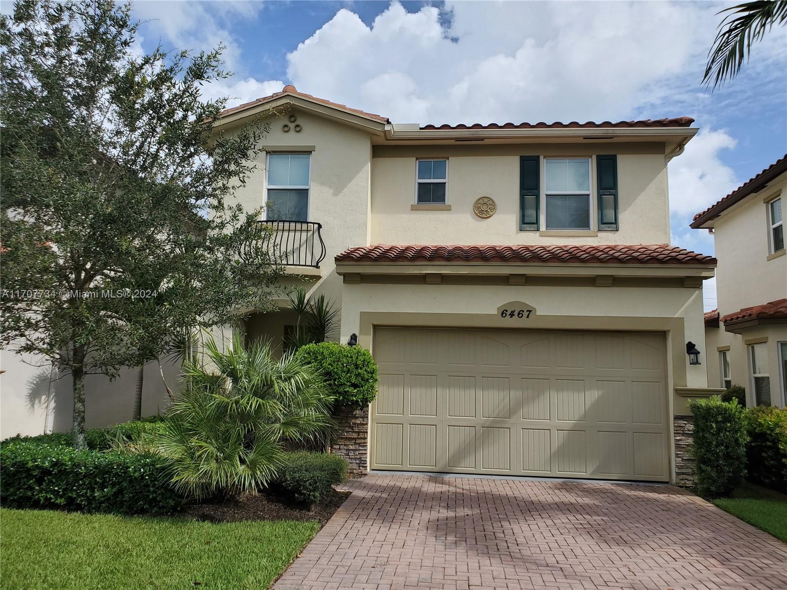 a front view of a house with garage