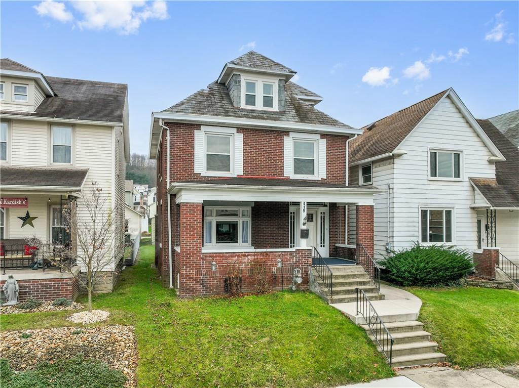 a front view of a house with a yard