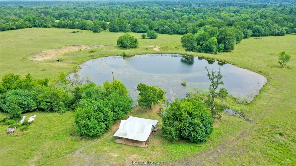 an aerial view of a house with yard swimming pool and outdoor seating