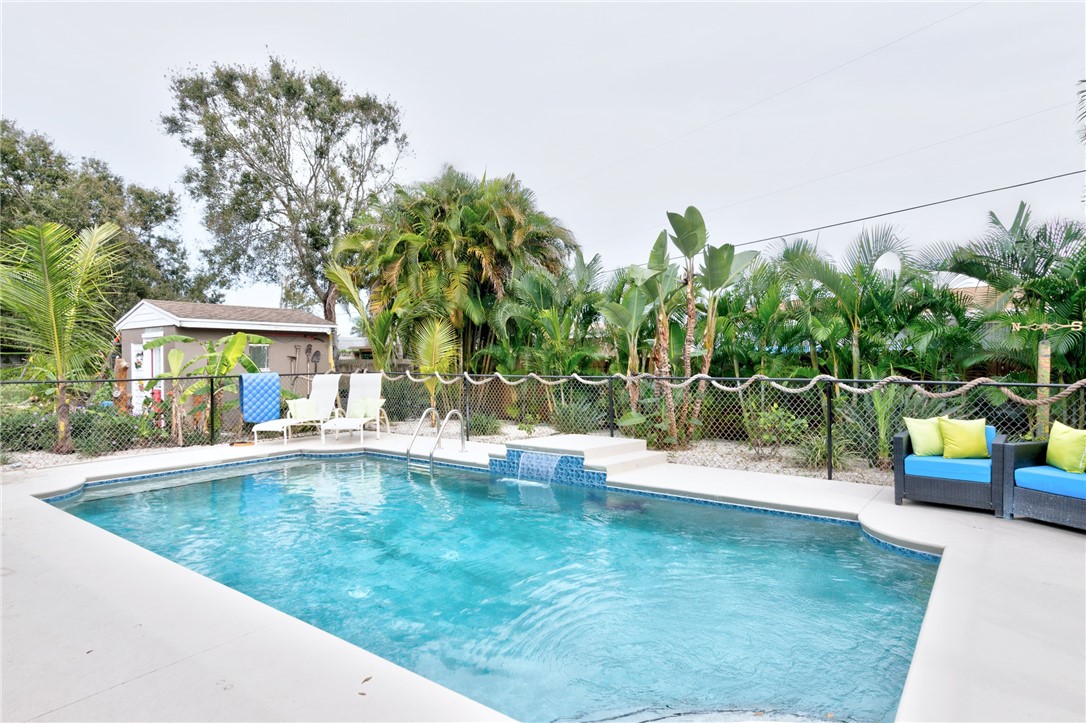 swimming pool view with a garden space