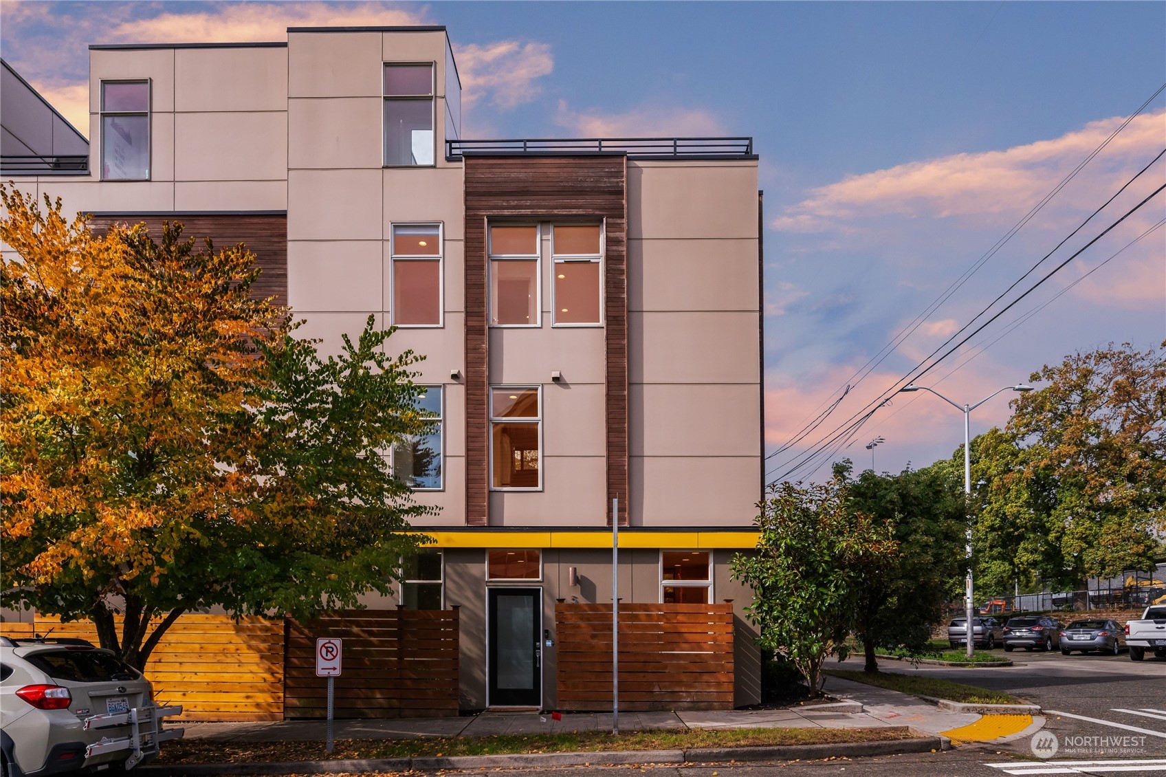 a front view of multi story residential apartment building with yard