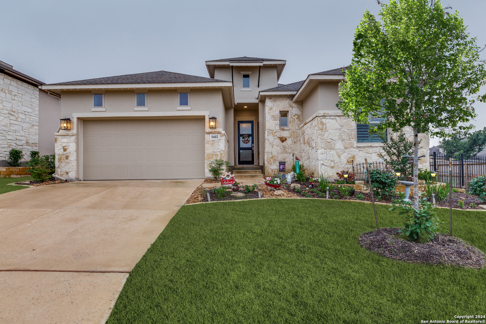 a front view of a house with a yard and garage