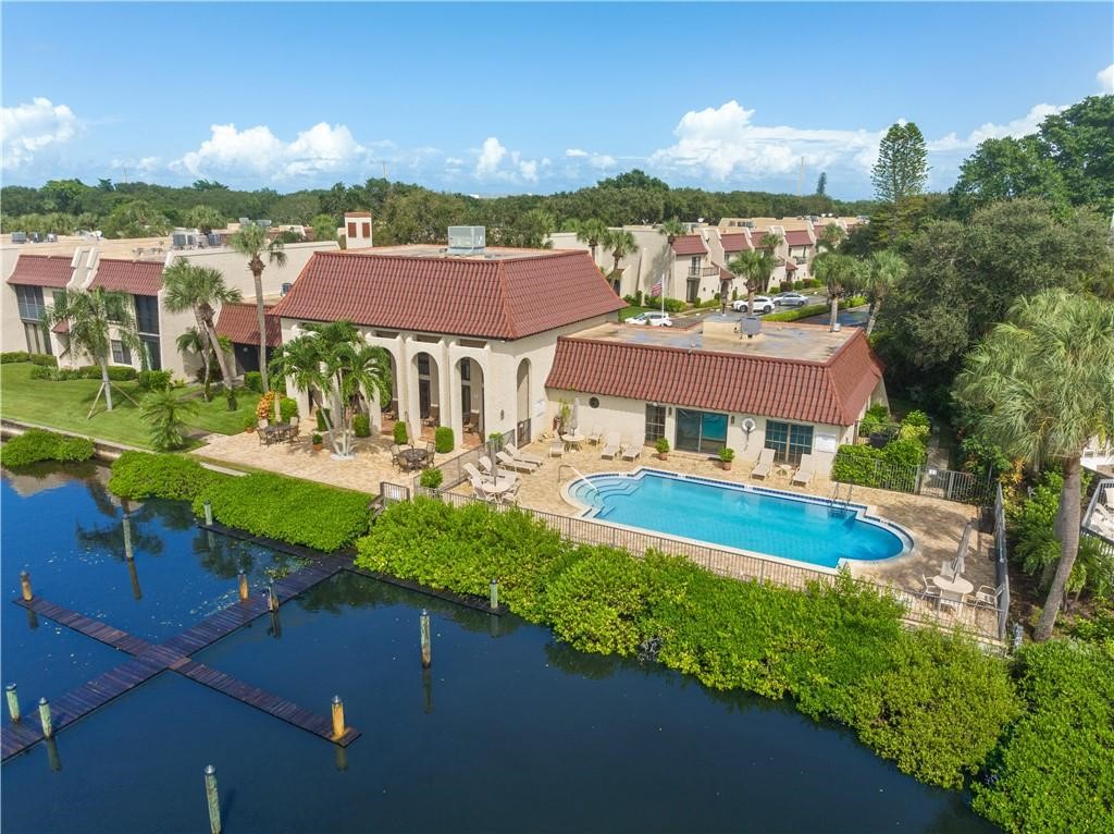 an aerial view of a house with yard pool table and chairs