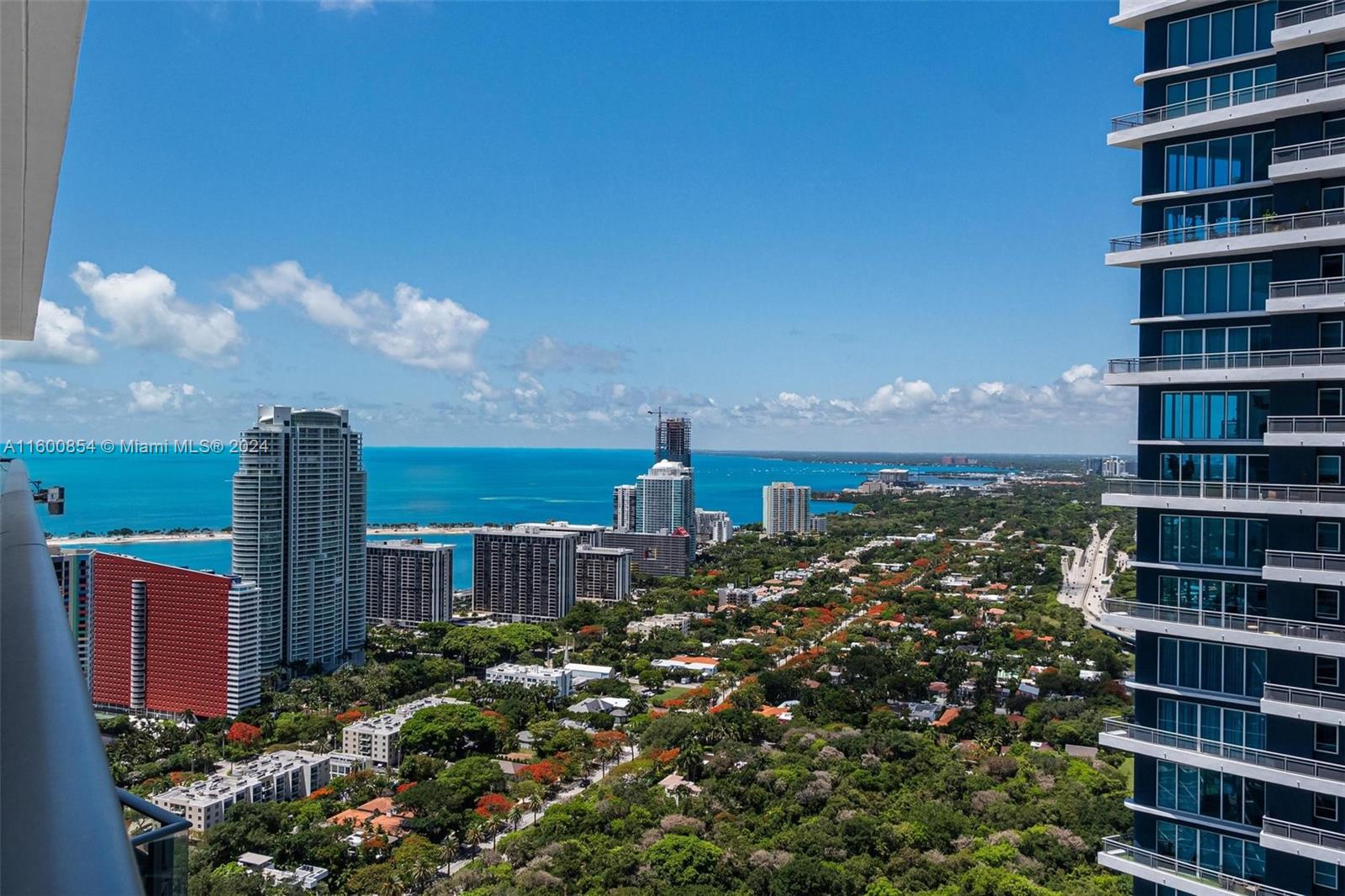 a view of a city with tall buildings and a big yard