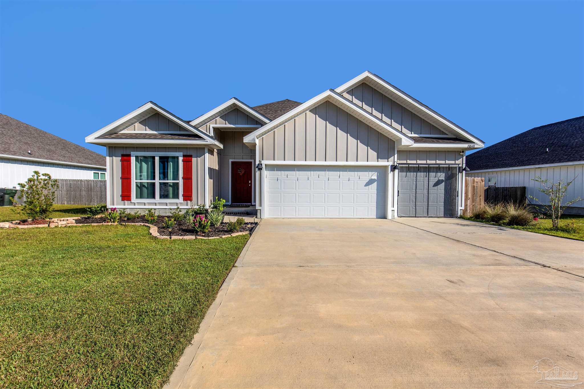 a front view of a house with yard and green space