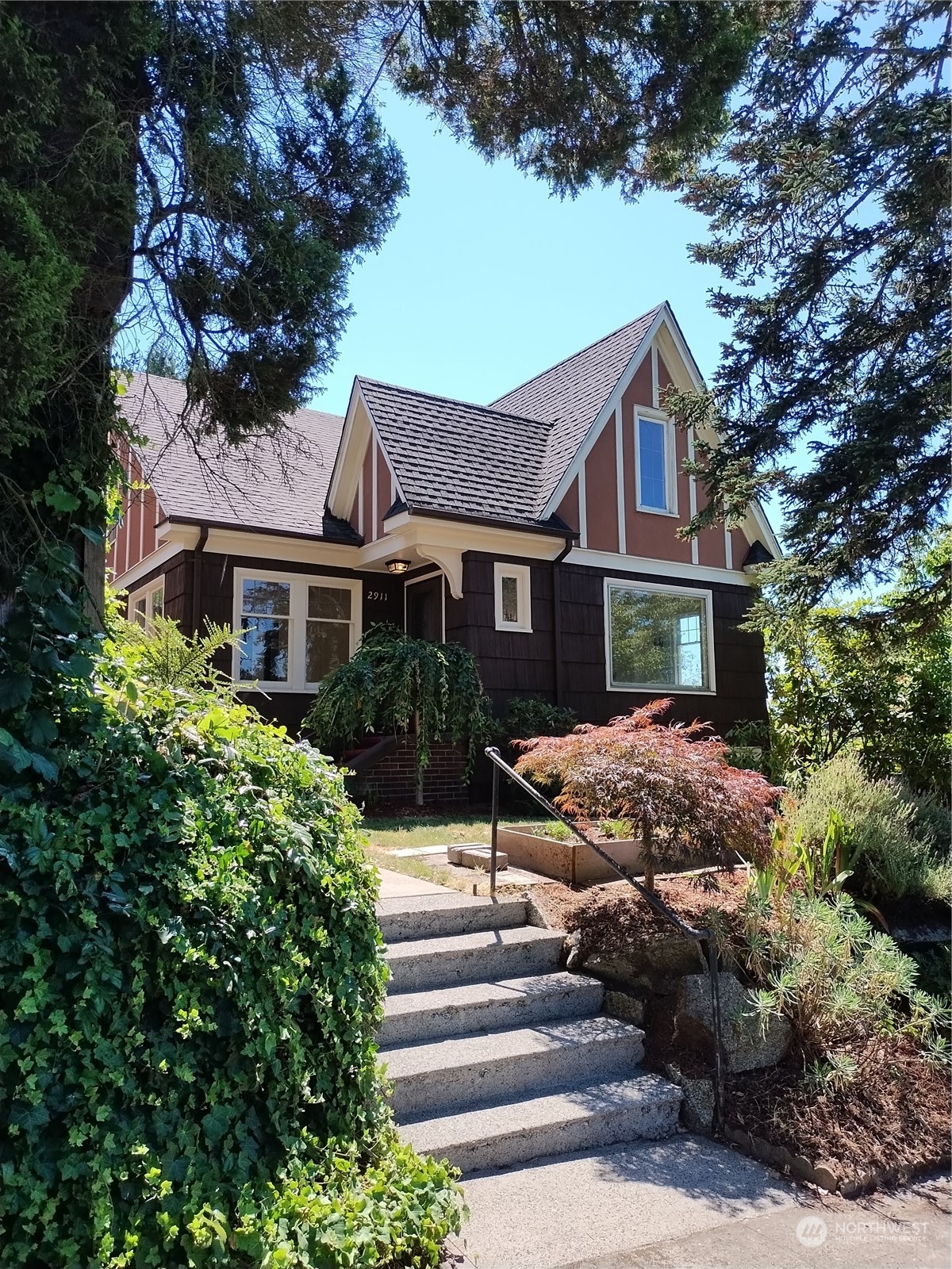 a front view of a house with a garden