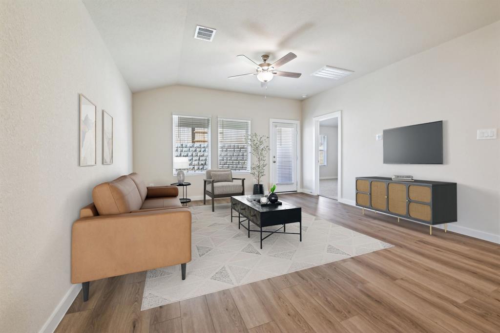 a living room with furniture and a flat screen tv