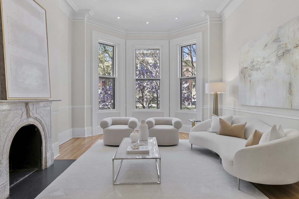 a living room with furniture fireplace and window