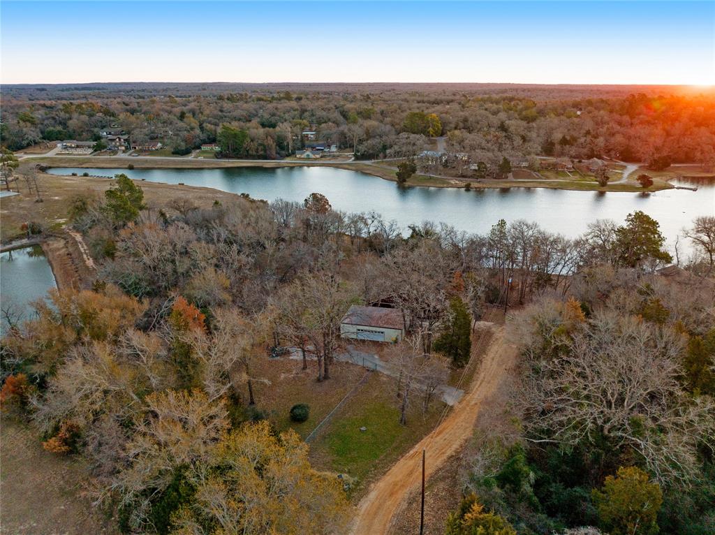 an aerial view of residential house with outdoor space and lake view