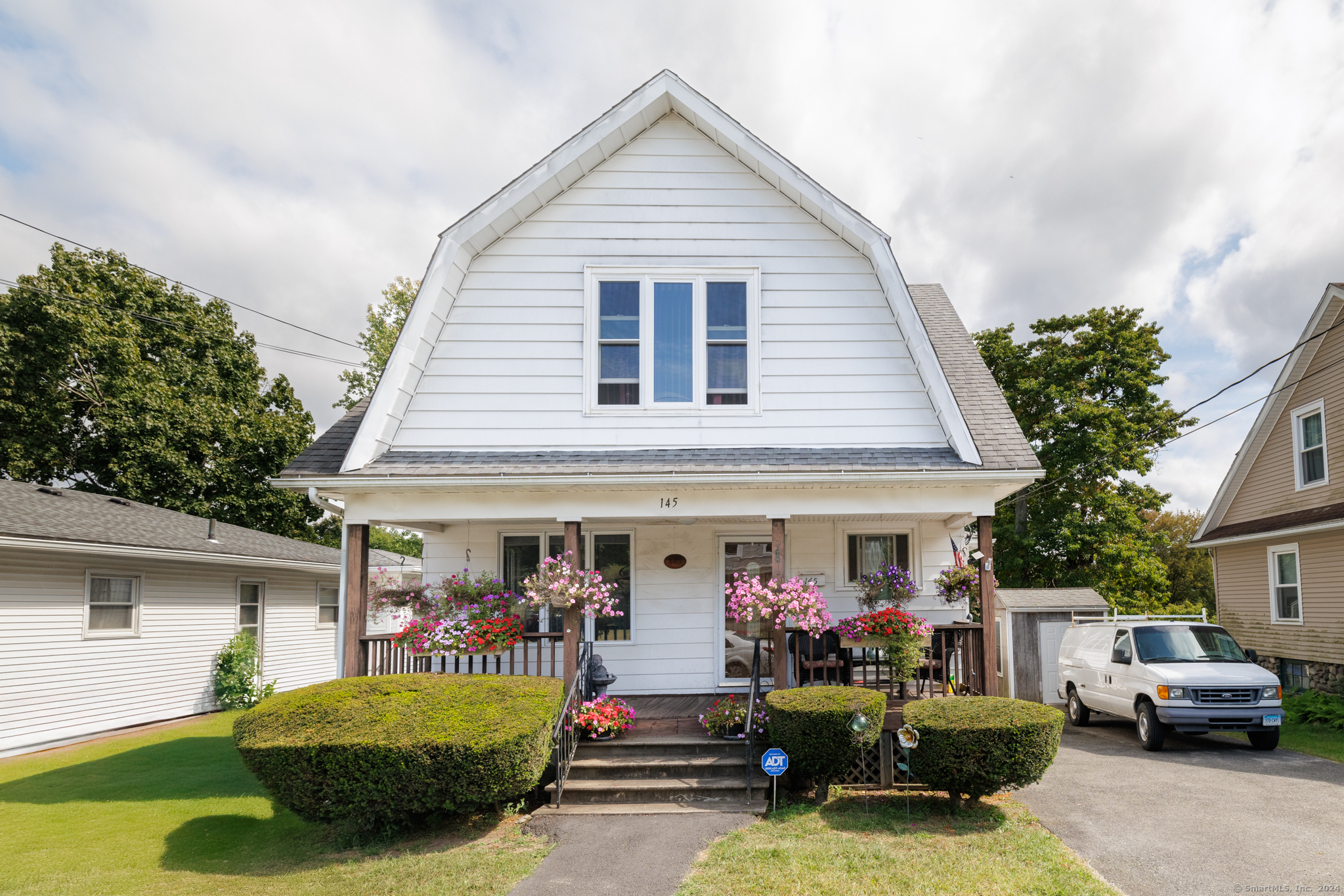 a view of a house with a porch and furniture