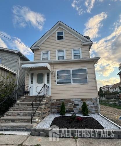 a front view of a house with stairs