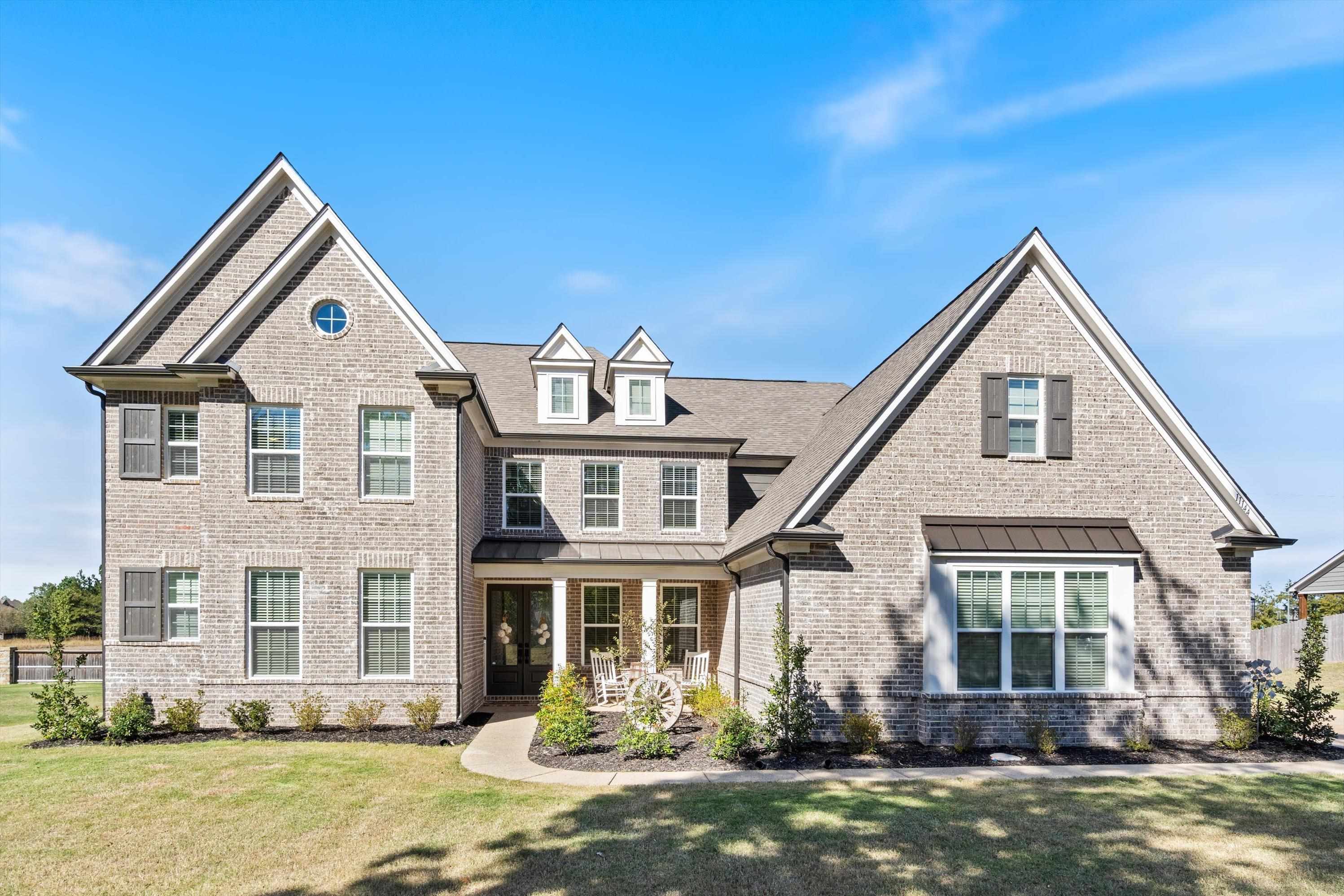 a front view of a house with a yard