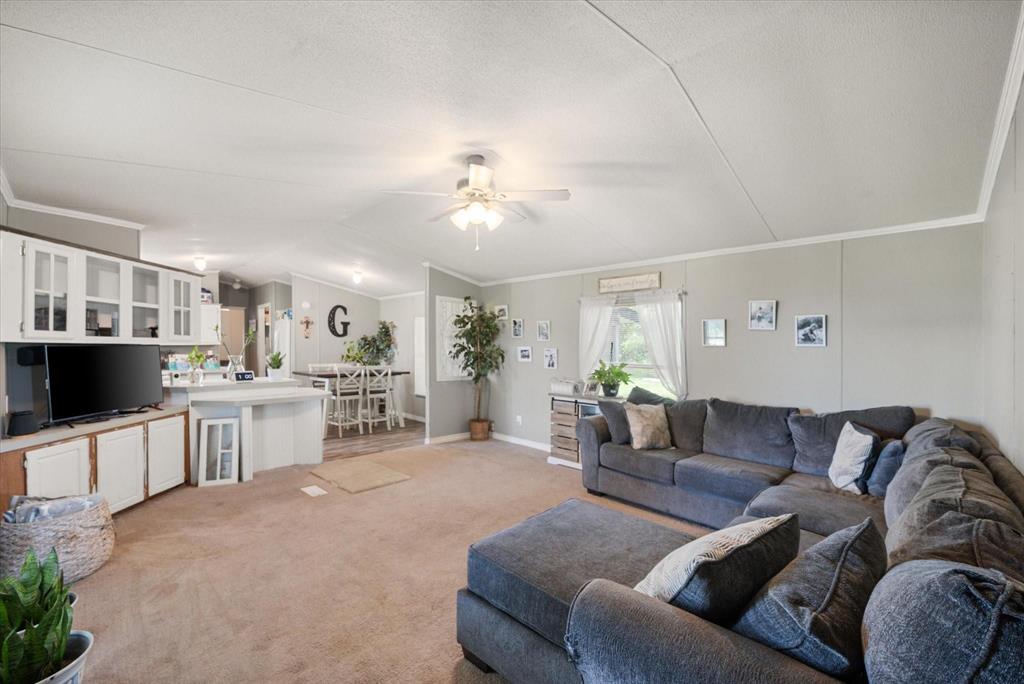 a living room with furniture a dining table and kitchen view