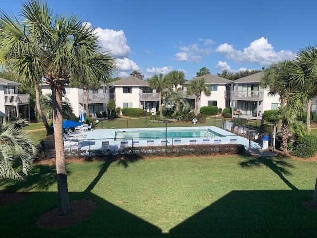 a view of a house with swimming pool and a yard