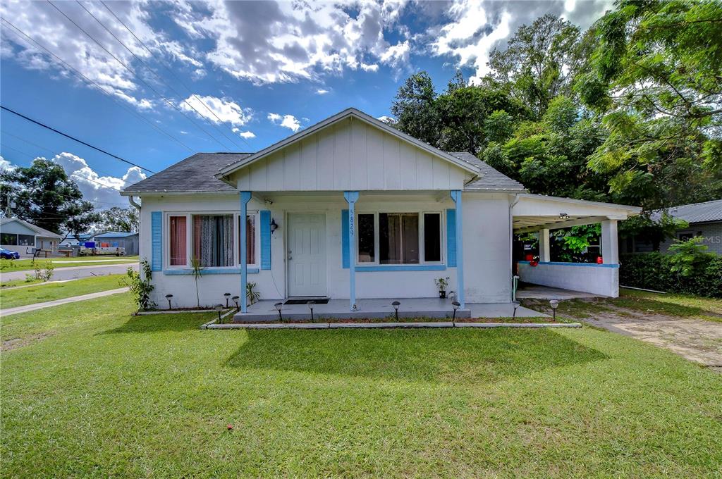 a view of a house with a yard porch and sitting area