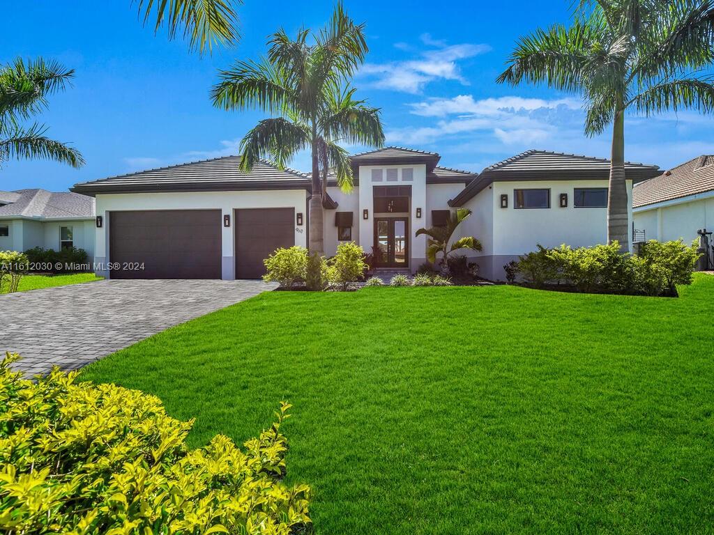 a front view of house with yard and green space