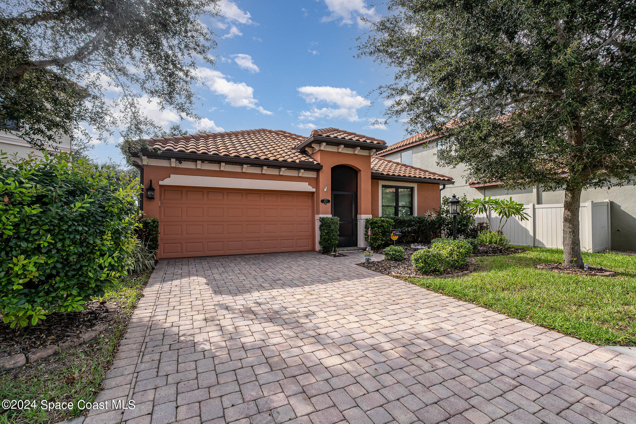 a front view of a house with a yard and a garage