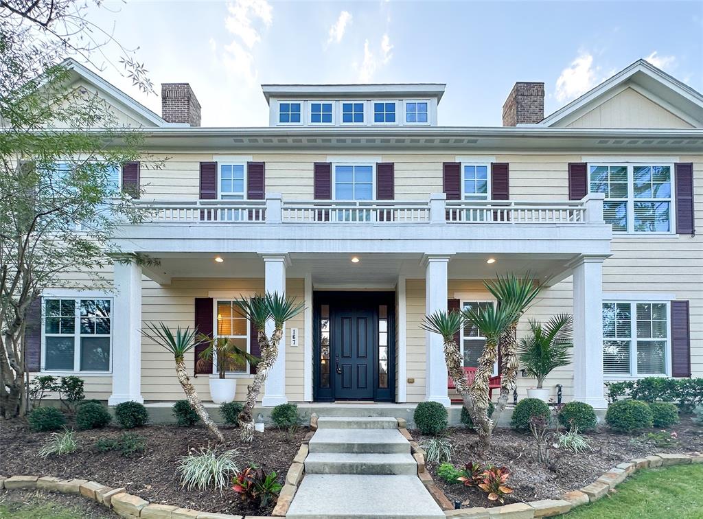 a front view of a house with garden and plants